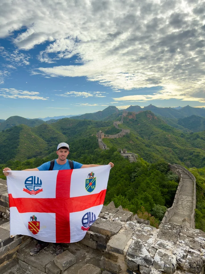 Holding a Bolton Wanderers flag on the Great Wall of China