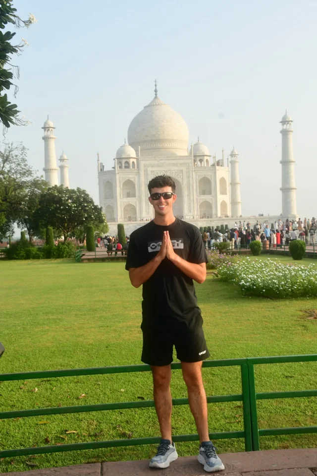 Standing in the gardens in front of the Taj Mahal in Agra, India